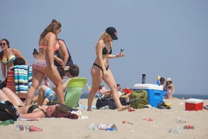 Two thick white girls in bikinis on the beach with big asses