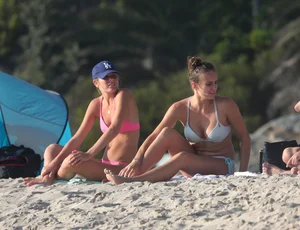 Two sexy friends out on the beach in bikinis