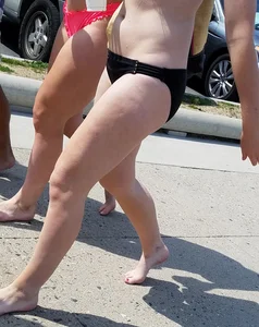 Cute brunette looking sexy in black bikini with friends