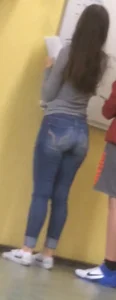 College candid teen in tight blue jeans in class by the marker board creepshot