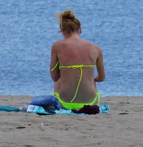 Sexy ass blonde milf on the beach in a thong with cameltoe and bending over
