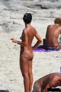 Smoking milf at a nude beach with a hairy pussy