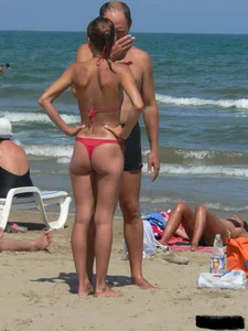 A bunch of hot babes on the beach in thong bikinis