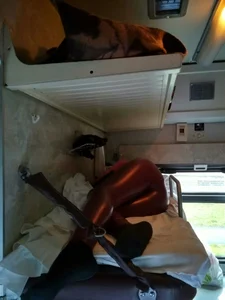 Candid girl wearing tight leather pants asleep in the public train sleeping car
