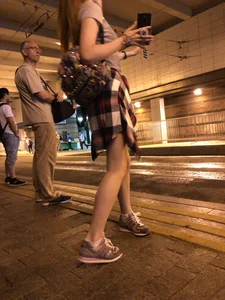 Cute Teen in Shorts on the Tram Stop