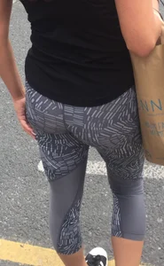 Sexy girl walking in grey patterned leggings with friend in tight jeans