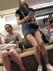 Two Girls With Hot Long Legs in Mini Shorts and Sneakers in the Subway Train Candid Photo Gallery