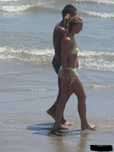 Sexy blonde on the beach in a yellow thong bikini