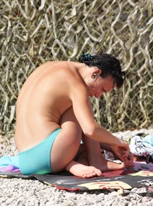 Cute brunette lady topless at the beach with awesome tits