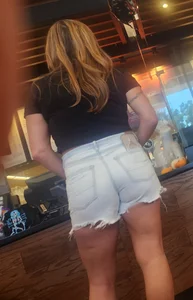 Short shorts on hot milf buying coffee