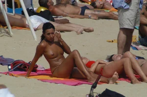 Topless girls on a beach in Barcelona