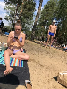 Milf Sitting in a Swimsuit Sitting on a Beach With Her Phone Creepshots