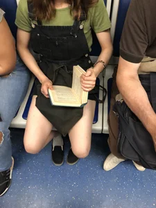 Girl with Hot Spread Legs in White Socks Reading in Subway Train with Her Shoes Half Taken Off Candid Photo