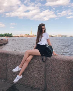 Girl with Great Thin Legs Sitting on the Embankment Street Candid