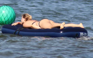 Black thong bikini blonde with a nice ass out on a tube in the water