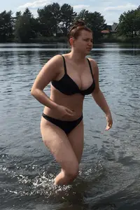 Big boobed babe at the lake in a black thong with blonde friend
