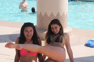 Girls in Swimsuits Fooling Around By the Pool, One Showing Off Her Leg