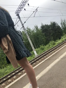 Hot candid girl wearing a dress on a train station platform