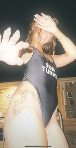 Non-candid girl with a snake tattoo coming out of the pool