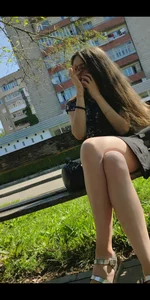 Hot Tall Girl in a Dress and Pantyhose Sitting on the Street Bench with Crossed Legs Candid