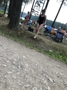 Cute Barefoot Girl in a Black Body Swimsuit Walking on a Road