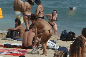 Topless girls on a beach in Barcelona