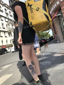 Amazing cute candid food delivery girl with lots of tattoos crossing the street