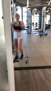 Hot blonde working out at the gym in shorts and crop top