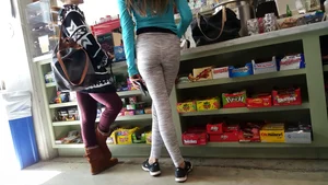 Teen in grey leggings standing with crossed legs at the shop