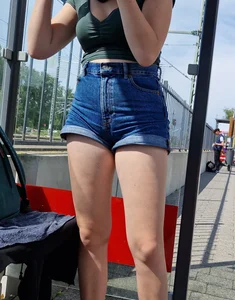 A Cute Candid Girl With Long Gorgeous Legs in Jean Shorts Sitting at the Bus Stop Creepshots