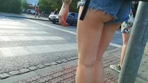 Girl walking in denim shorts showing some of her ass cheeks