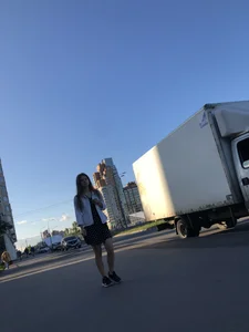 Extremely Cute Girl in a Skirt With a Backpack Passing By on the Street Gallery