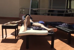 Blonde laying out in a blue bikini with a sexy body
