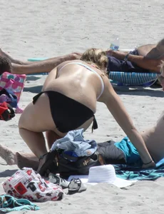 Big boobed thick blonde on the beach in a bikini