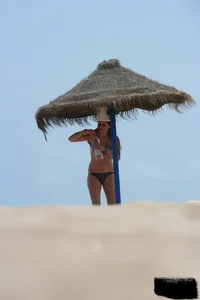 Hot beach girl undressing and going topless
