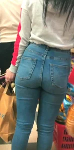 Skinny brunette with a nice booty in line in tight jeans