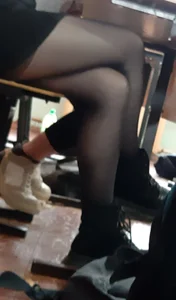Legs of candid college teens wearing pantyhose in class