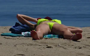 Sexy ass blonde milf on the beach in a thong with cameltoe and bending over