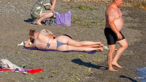 Large collection of hot beach girls lying on the beach and bending over