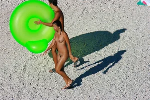 FKK Nudists playing in the water with floater