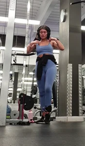 Bending gym babe stern face
