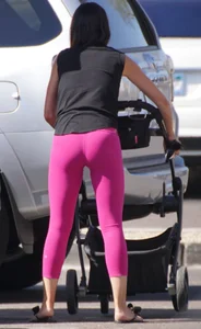 Milf brunette in purplish-pink leggings looking sexy in the parking lot
