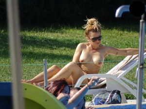 Topless lady at the pool with nice tits