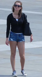 Cute girl with nice legs in short denim shorts