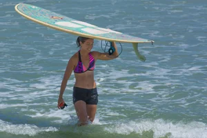 Candid girls surfing on the beach