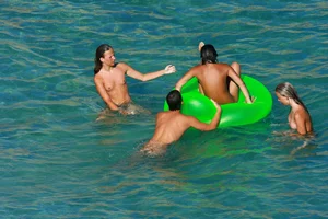 FKK Nudists playing in the water with floater