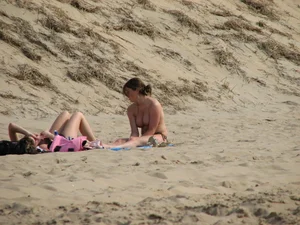 Topless beach girl with nice titties with her friend in a bikini