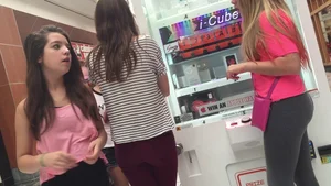 Little blonde teen in grey leggings at the mall with her friends