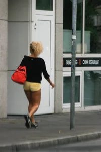 Blonde looking sexy walking in short yellow shorts