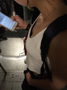 Sexy Asian showing bra under shirt and a little cleavage